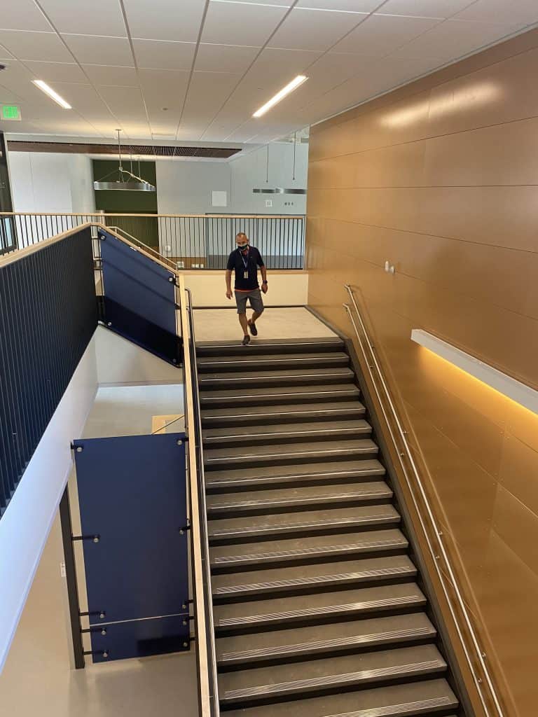 Brooks walks down a flight of stairs at the school on Aug. 19 as staff prepared for the first day of school Sept. 7.