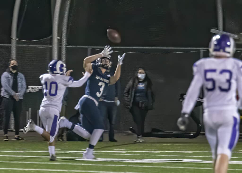 A Gig Harbor running back looks for daylight around the left side.