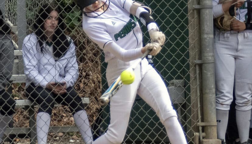 Glory Eastabrook, turns on a ball with perfect technique, for a hit in the 6-0 win as Pitcher Alli Kimball watches from the dugout.