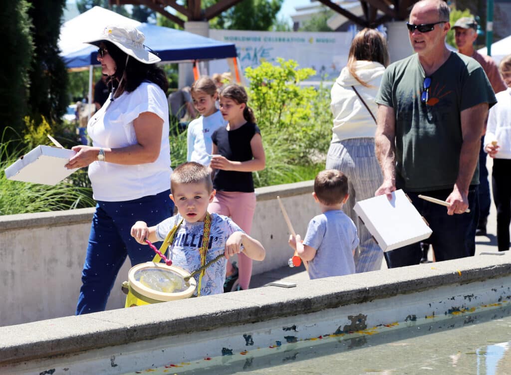 Spectators joined in the parade between stages, some using pizza boxes as drums, at Tuesday's Make Music Day at Uptown Gig Harbor.