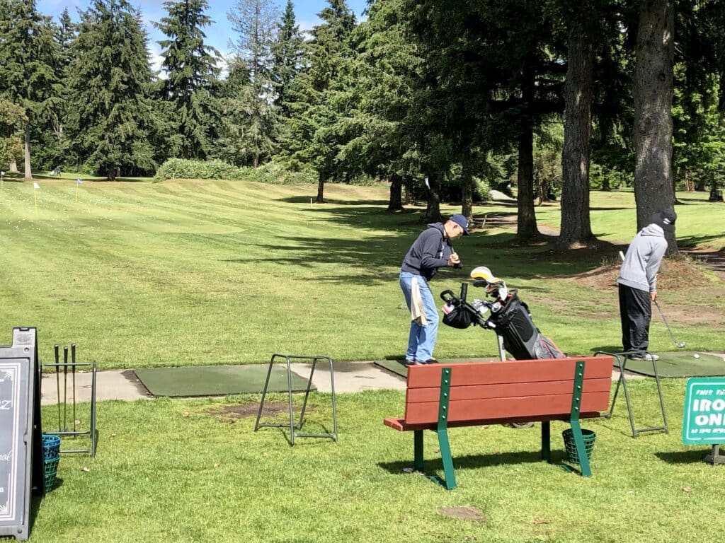 A golfer hits some drives at Madrona Links.