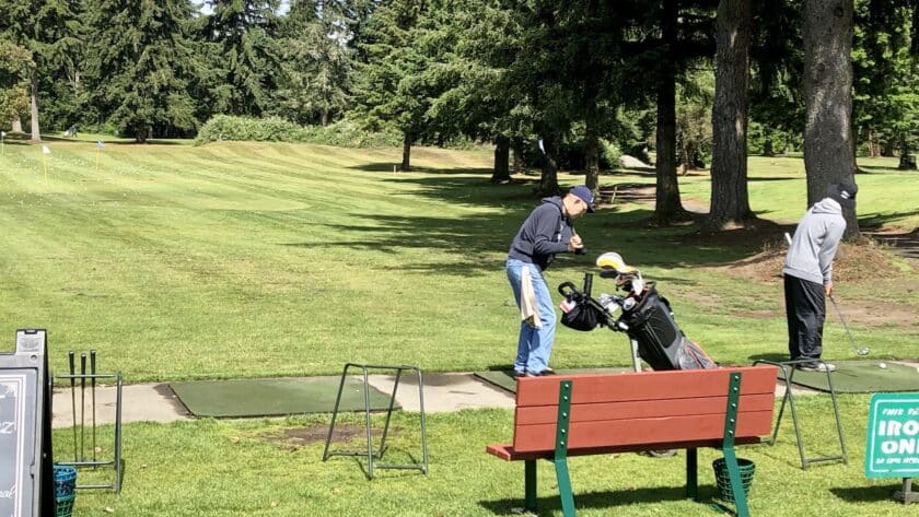 A golfer hits some drives at Madrona Links.