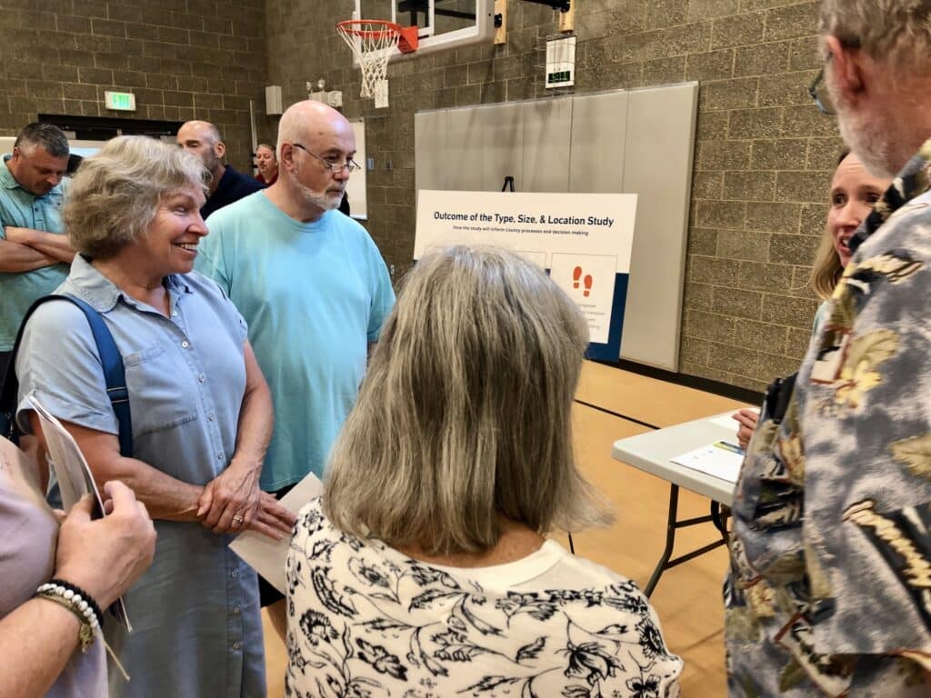 Island residents speak to county public works employees and consultants and one of several information tables.